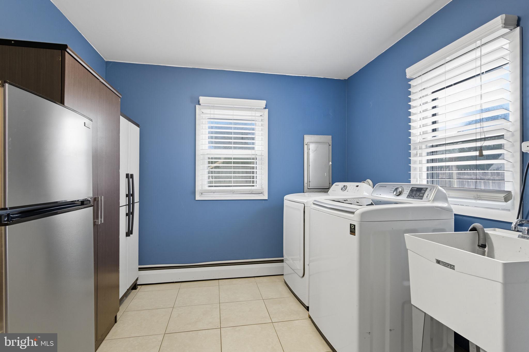 9 Newberry Lane Levittown, PA 19054 - Photo 11 of 36 a view of washer and dryer with kitchen in the background