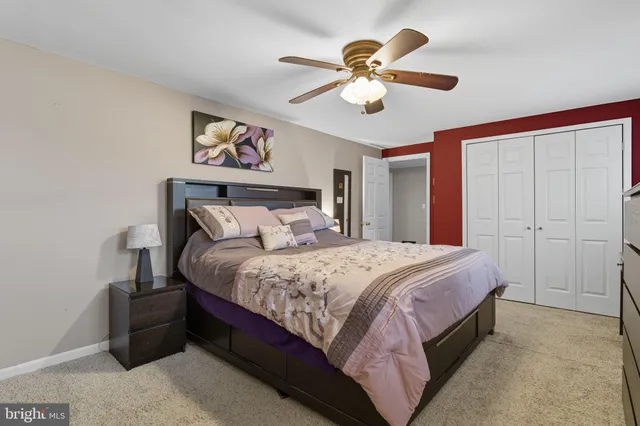 a bedroom with bed and a chandelier