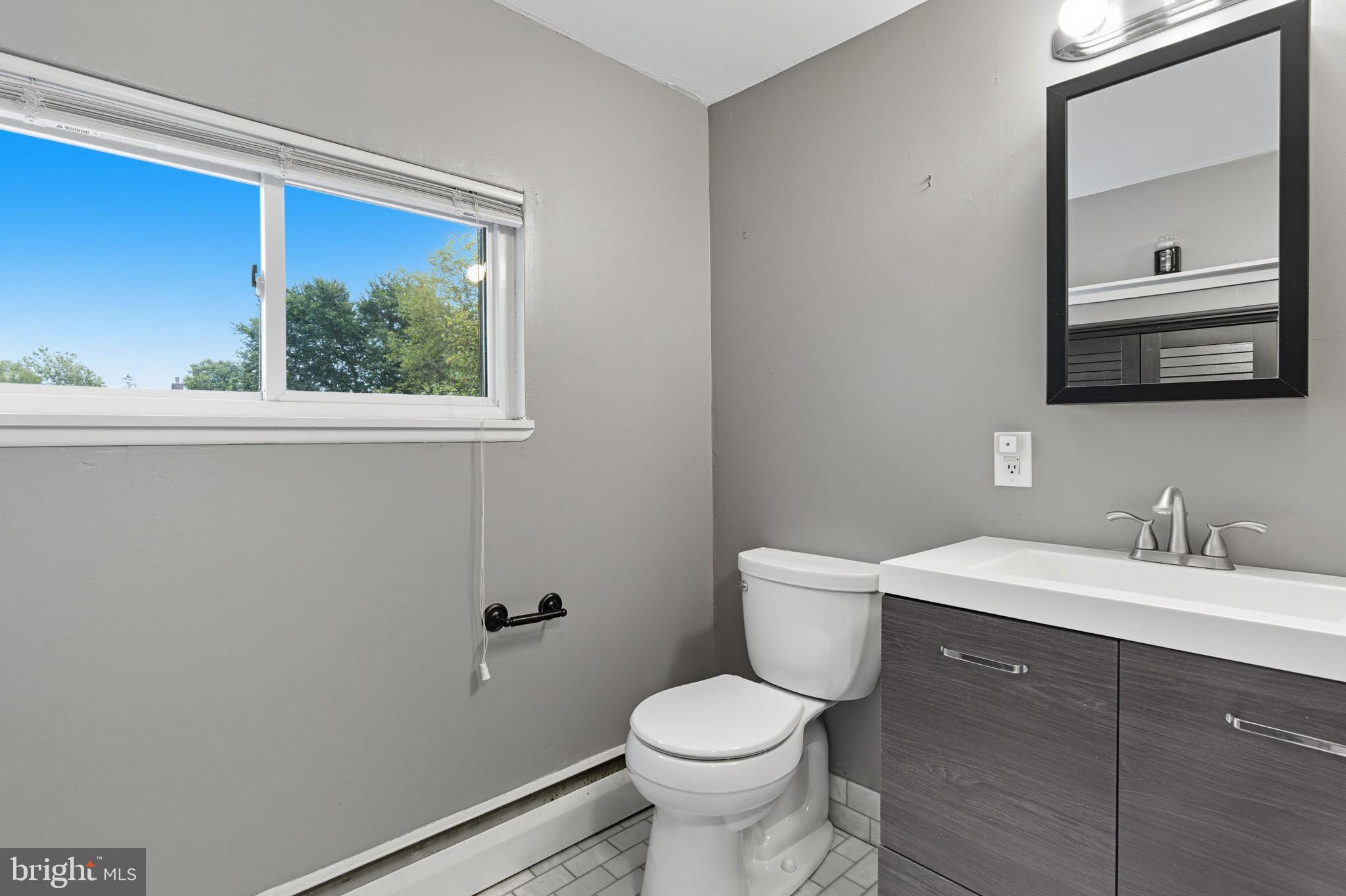 9 Newberry Lane Levittown, PA 19054 - Photo 23 of 36 a bathroom with a toilet a sink a vanity and mirror