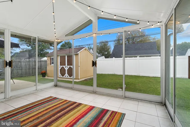 a view of a patio with a table and chairs under an umbrella