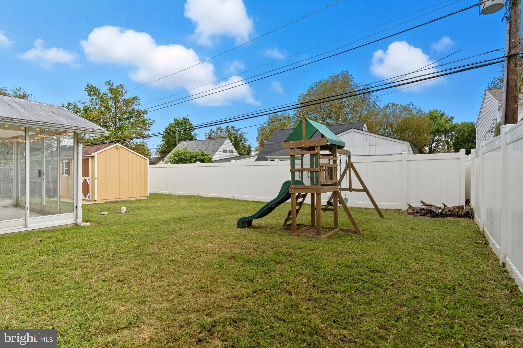 9 Newberry Lane Levittown, PA 19054 - Photo 28 of 36 a view of backyard with a slide and a swing