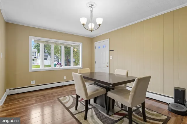 a kitchen with stainless steel appliances granite countertop a refrigerator a stove and a sink with wooden cabinets