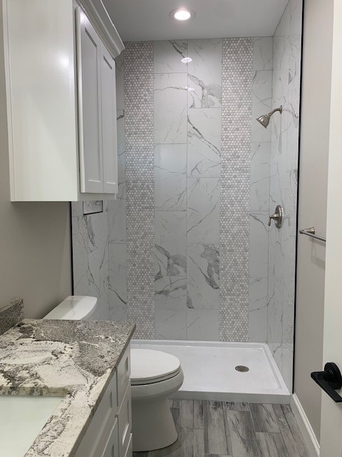 592 West Garrett Street Robstown, TX 78380 - Photo 12 of 15 a bathroom with a granite countertop sink a toilet and shower