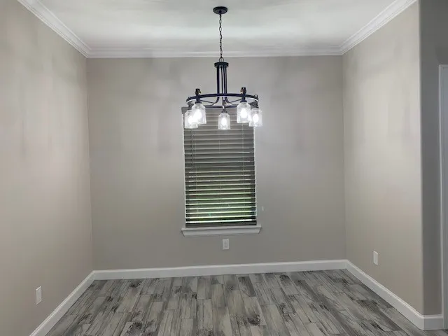 a view of wooden floor and windows in a room