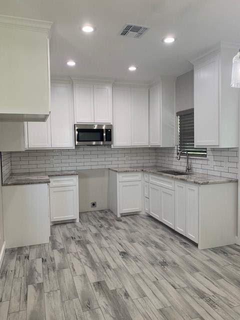 592 West Garrett Street Robstown, TX 78380 - Photo 7 of 15 a kitchen with granite countertop a sink and cabinets