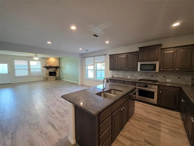 a kitchen with a stove and a sink