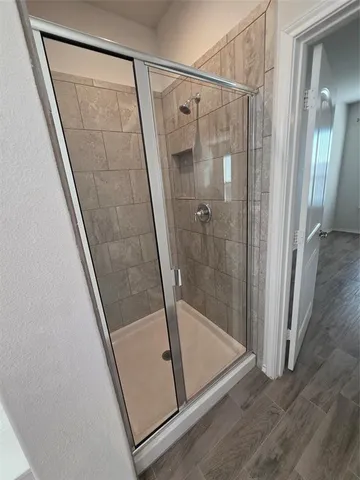 a bathroom with a shower and toilet