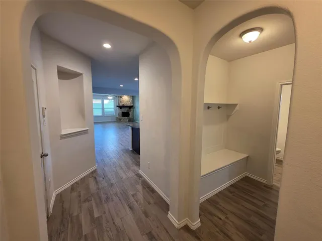a view of a hallway view with wooden floor and staircase