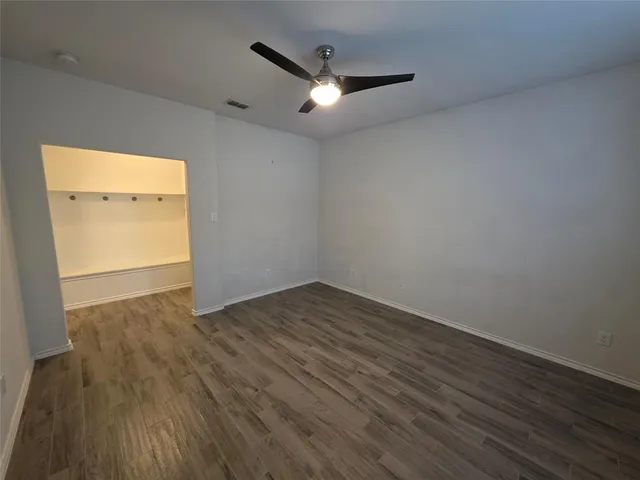 a view of a room with wooden floor and white walls