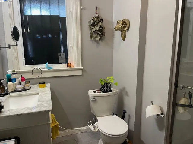a bathroom with a toilet a sink and mirror