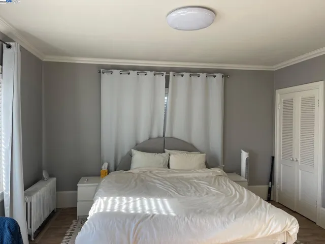 a bedroom with a bed and a chair