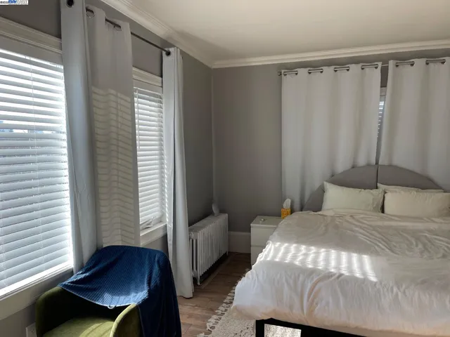 a bedroom with a bed and a window