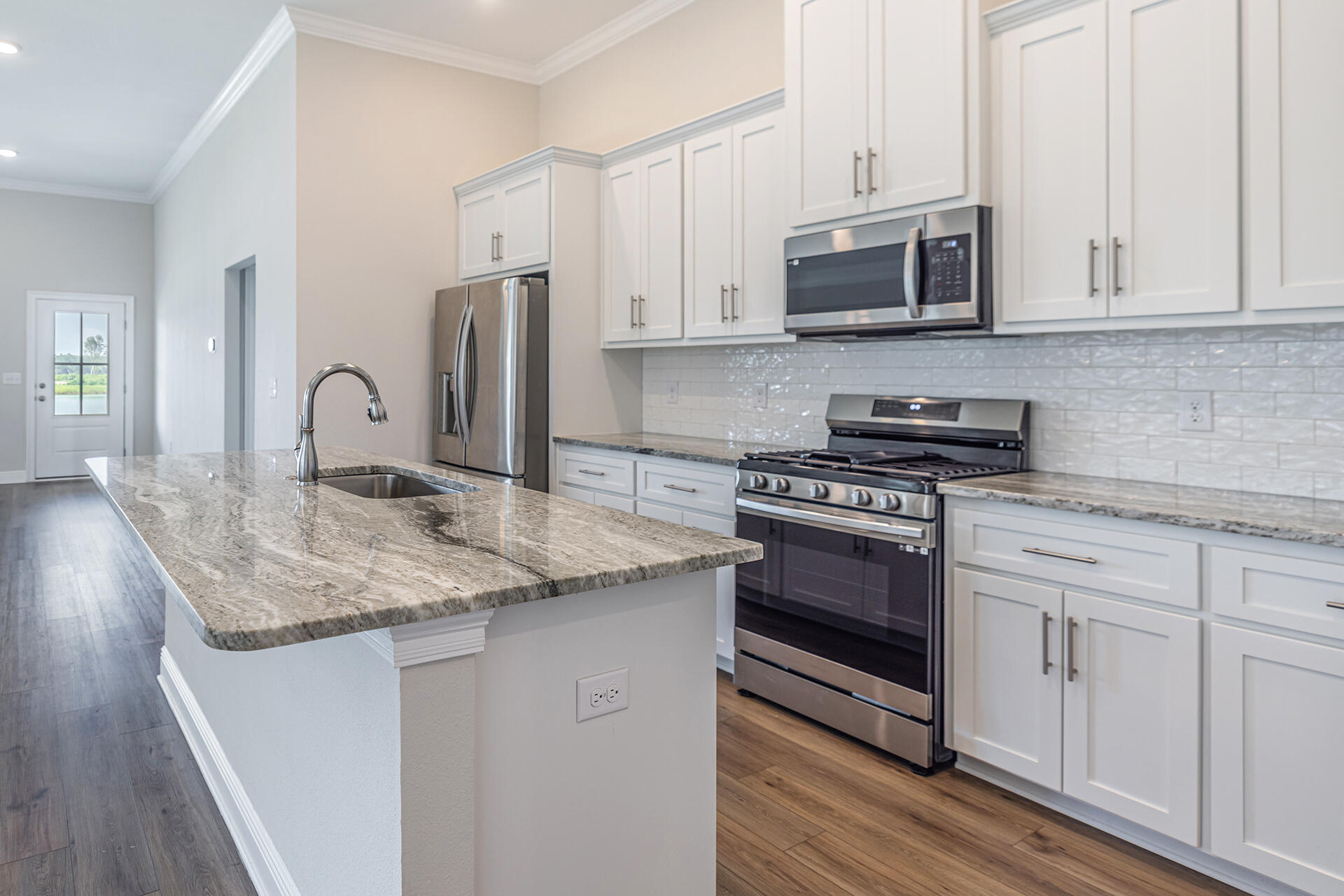 8959 Eureka Street Milton, FL 32583 - Photo 14 of 37 a kitchen with stainless steel appliances granite countertop a stove microwave and sink