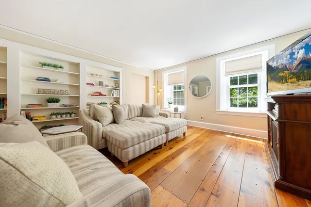 a bedroom with furniture and a flat screen tv