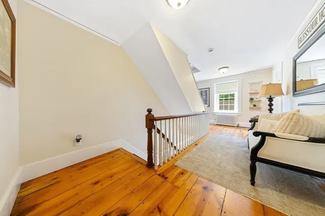 a view of a room with wooden floor and chair
