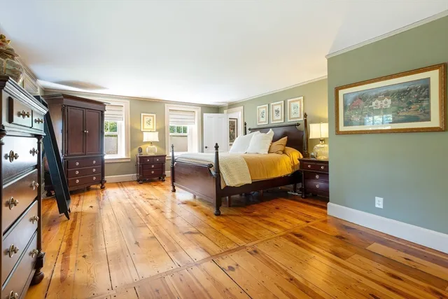 a bedroom with furniture and wooden floor