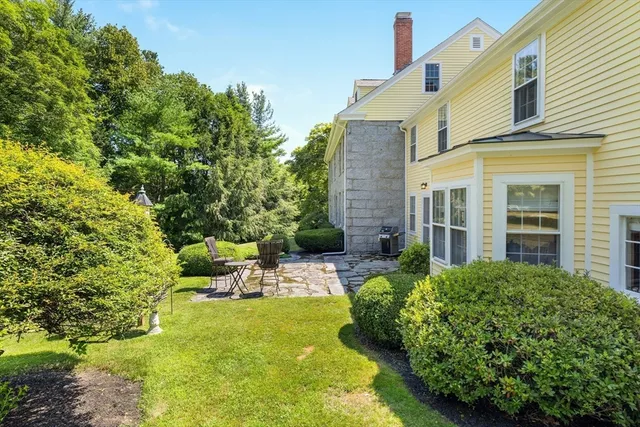 a view of backyard of house with green space