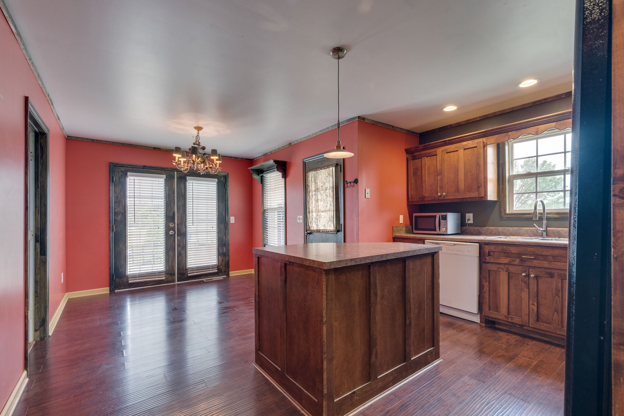 482 Rabbit Trail Road Leoma, TN 38468 - Photo 11 of 33 a kitchen with stainless steel appliances granite countertop wooden floors wooden cabinets a sink and a window