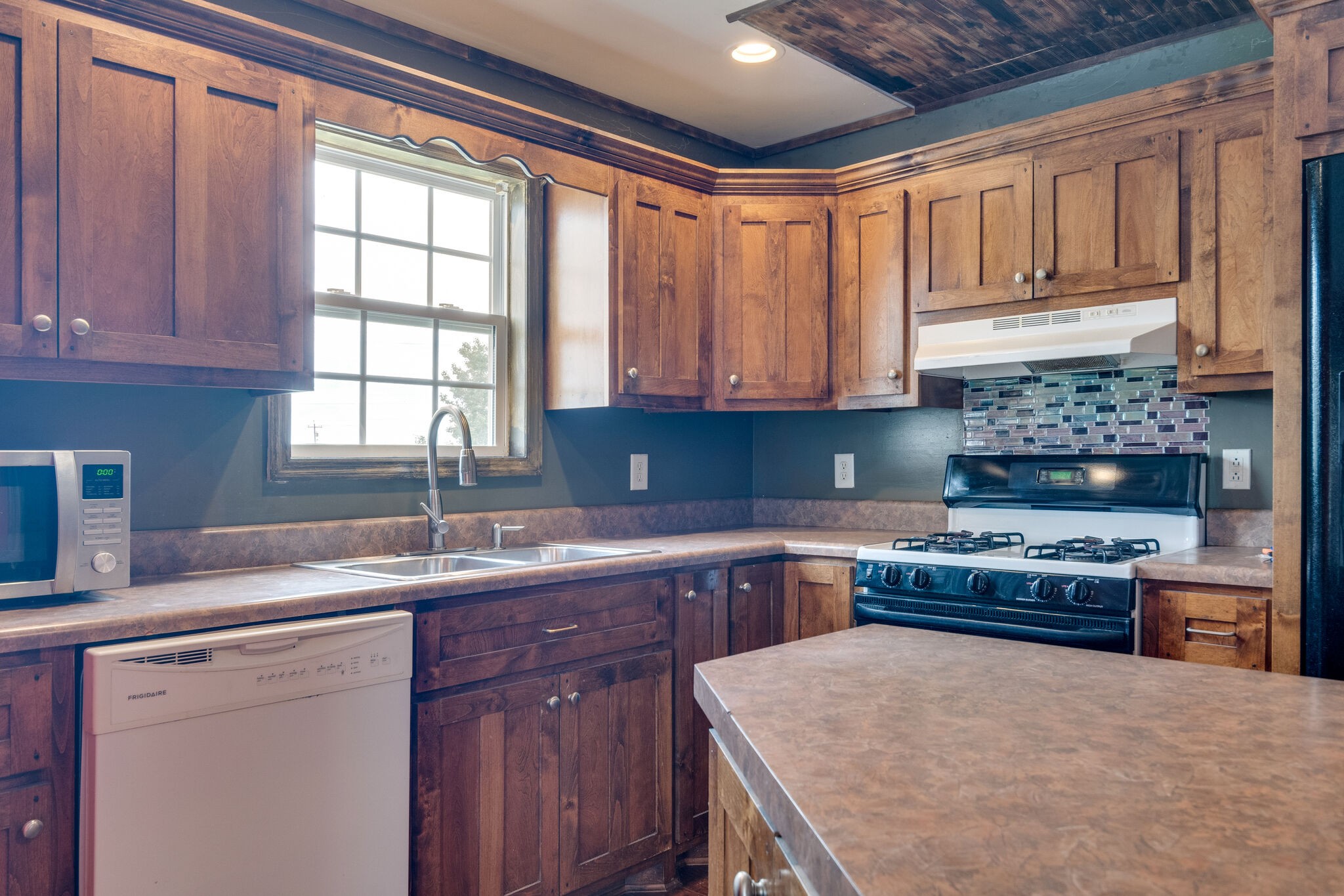482 Rabbit Trail Road Leoma, TN 38468 - Photo 13 of 33 a kitchen with kitchen island granite countertop a sink stove and cabinets