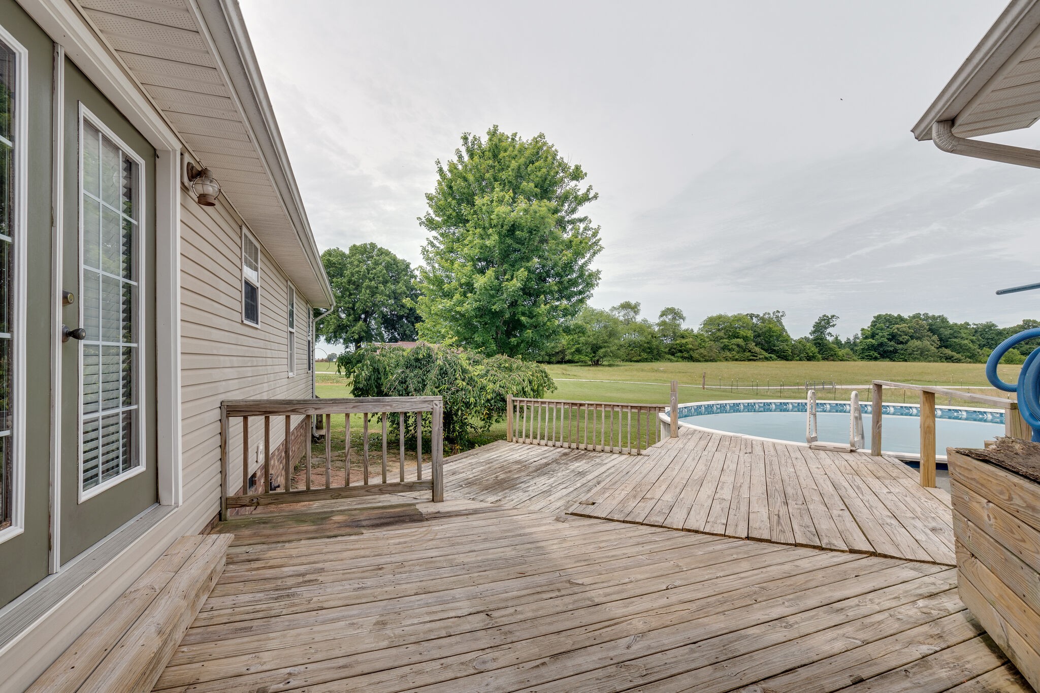 482 Rabbit Trail Road Leoma, TN 38468 - Photo 32 of 33 a view of a patio with dining table and chairs with wooden floor