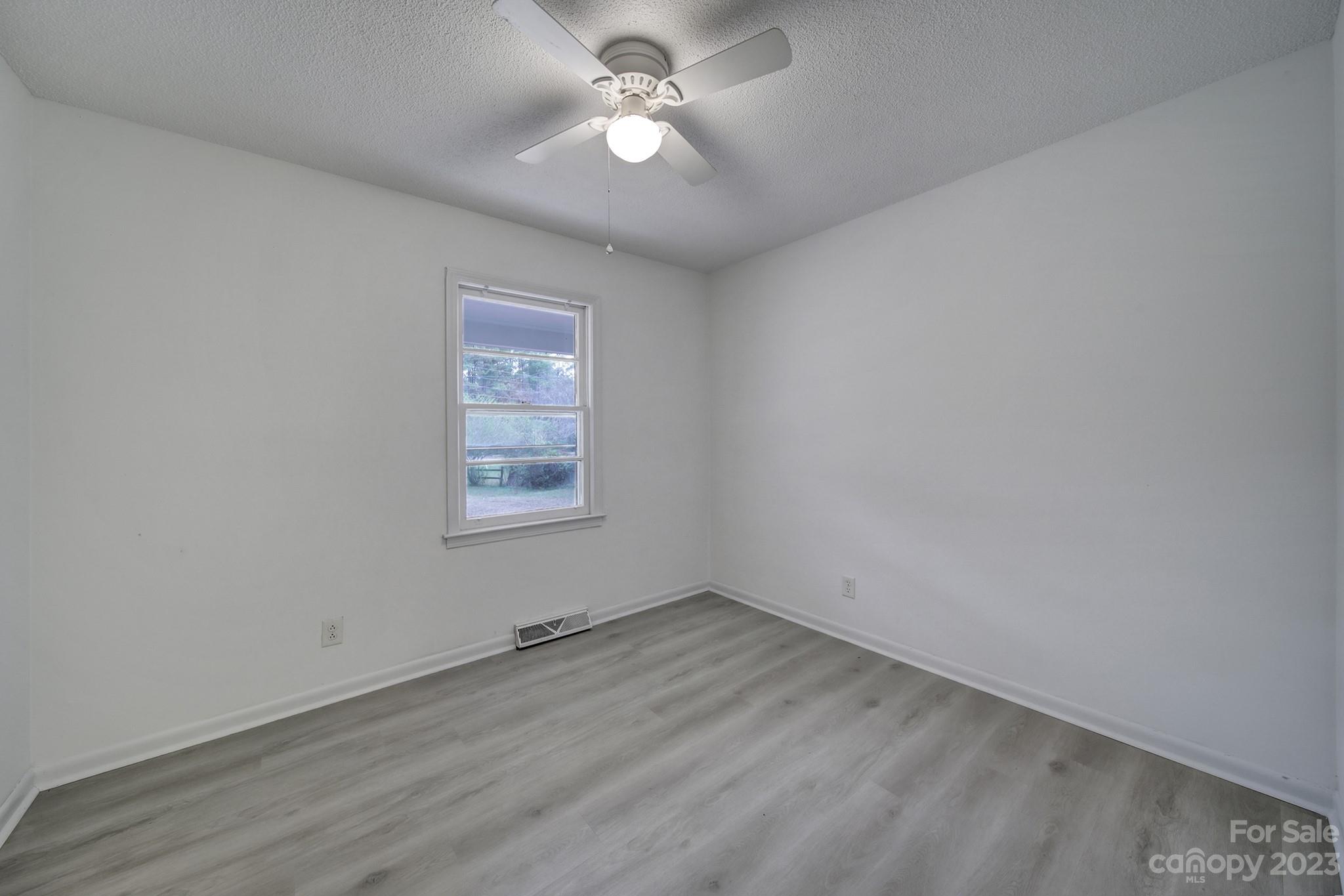 5119 State Rd S-46-557 Clover, SC 29710 - Photo 16 of 26 wooden floor in an empty room with a window