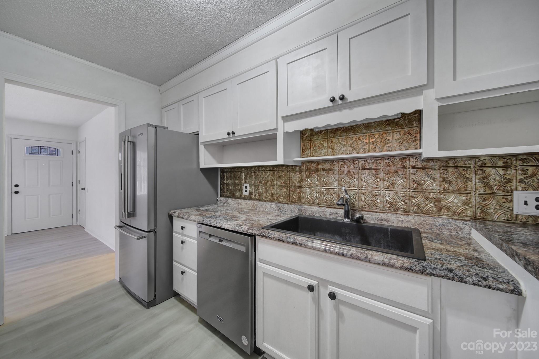 5119 State Rd S-46-557 Clover, SC 29710 - Photo 8 of 26 a kitchen with stainless steel appliances granite countertop a sink stove and refrigerator