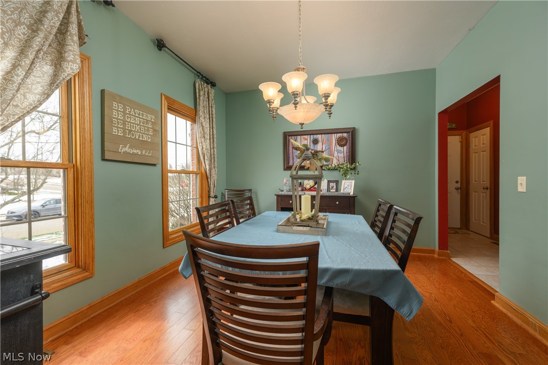 806 Forrest Ridge Drive Dover, OH 44622 - Photo 9 of 36 Dining area with light wood-style flooring and hanging lights