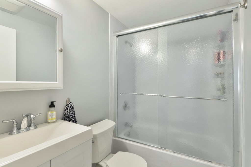37 Leonard Road, Unit 37 Boxborough, MA 01719 - Photo 13 of 20 a bathroom with a shower sink vanity mirror and toilet