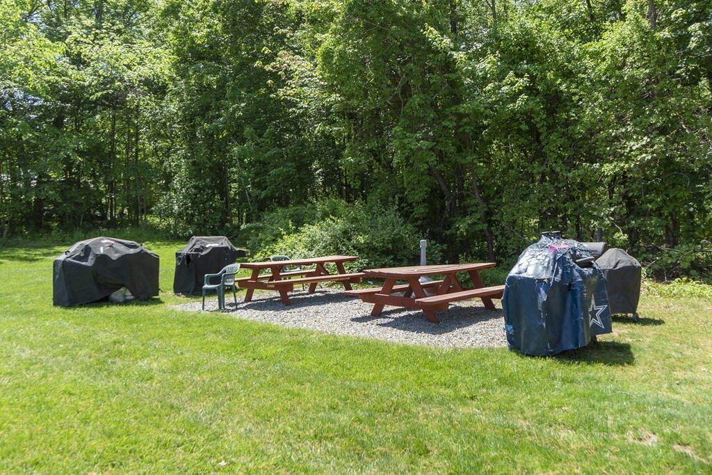 37 Leonard Road, Unit 37 Boxborough, MA 01719 - Photo 19 of 20 a view of a backyard with lawn chairs and a barbeque