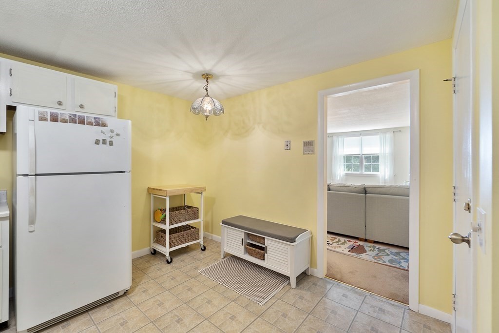 37 Leonard Road, Unit 37 Boxborough, MA 01719 - Photo 5 of 20 a utility room with cabinets dryer and washer