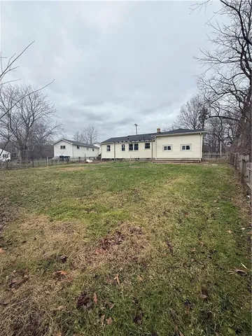 a view of a field with an trees in the background