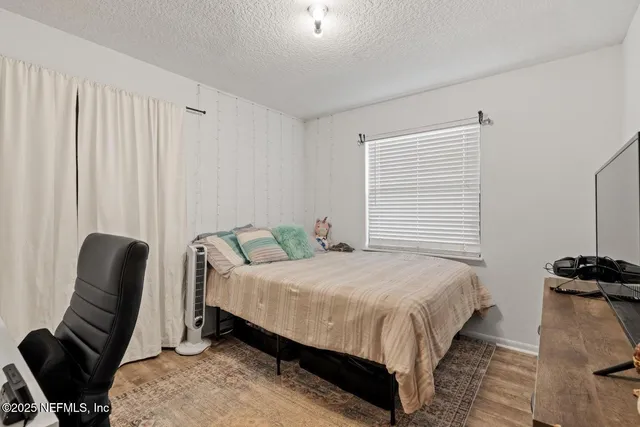 a bedroom with a bed and a chair