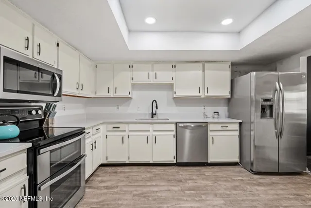 a kitchen with a refrigerator stove and microwave