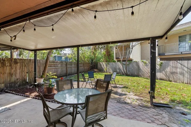 a patio with yard table and chairs
