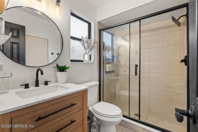 a bathroom with a sink toilet and shower