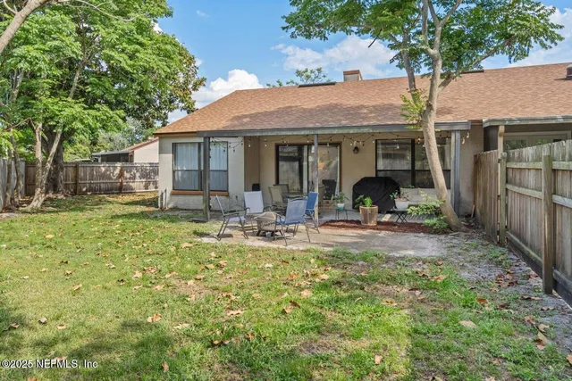 a view of a house with backyard porch and sitting area