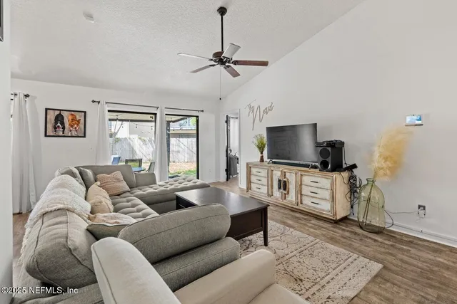 a living room with furniture and a flat screen tv