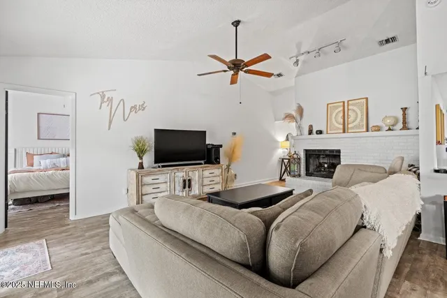 a living room with furniture a flat screen tv and a couch