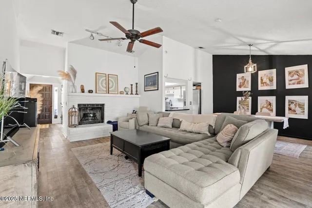 a living room with furniture fireplace and a window