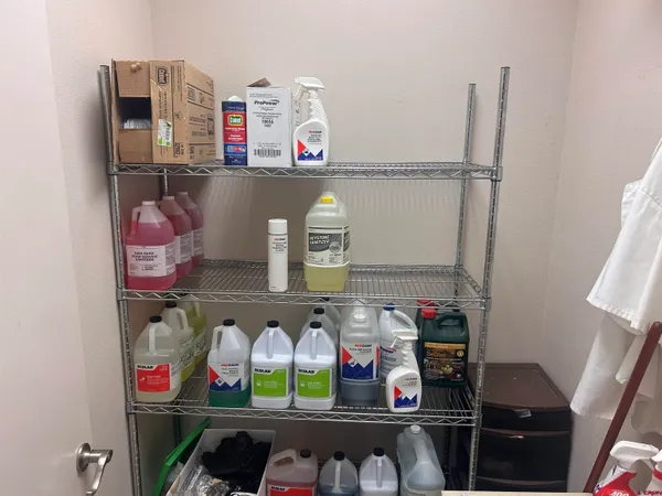 a cabinet with wine bottles and sink on it