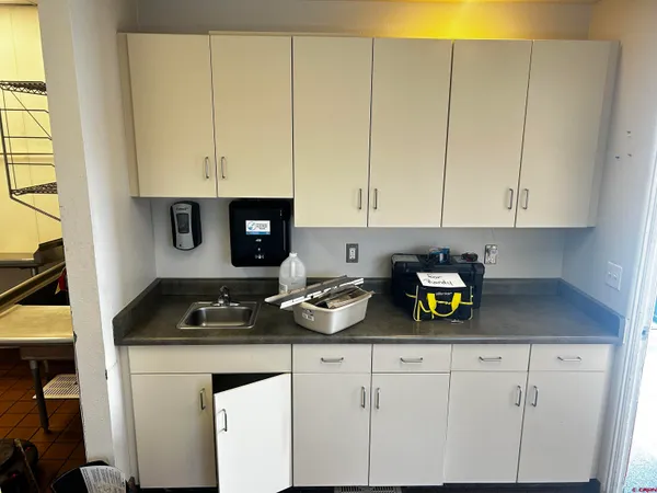 a kitchen with white cabinets and a stove