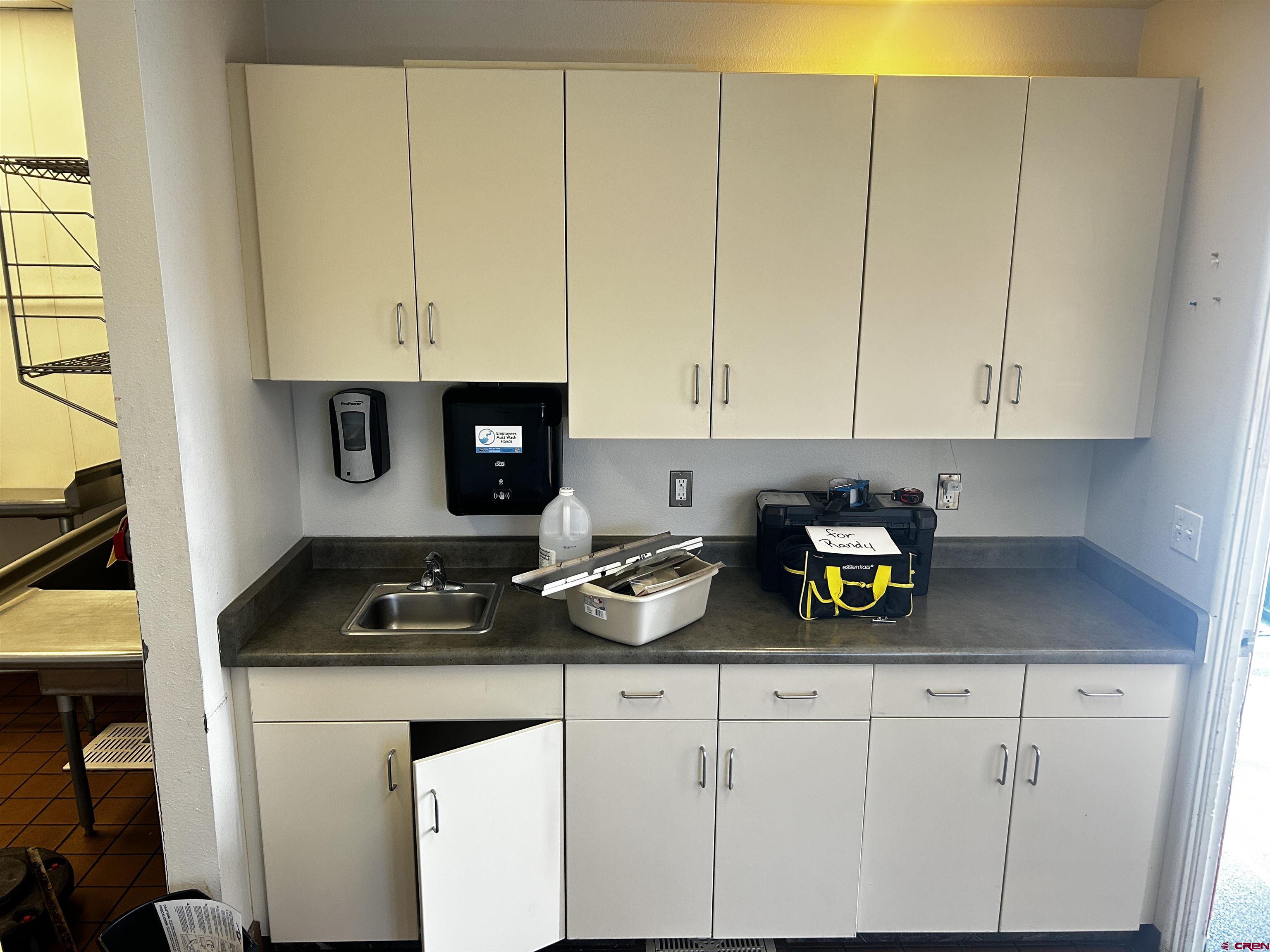 350 Stafford Lane, Unit 3511 Delta, CO 81416 - Photo 3 of 13 a kitchen with white cabinets and a stove