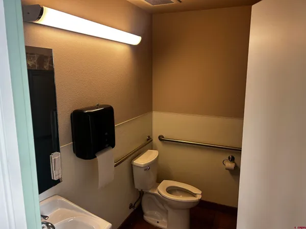 a white toilet sitting next to a bathroom sink
