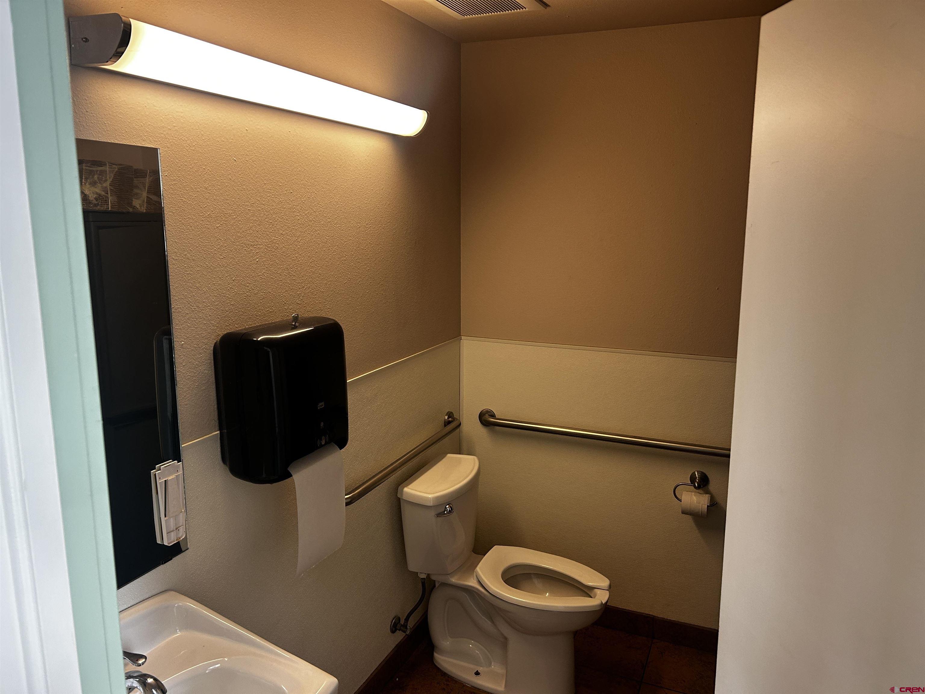 350 Stafford Lane, Unit 3511 Delta, CO 81416 - Photo 7 of 13 a white toilet sitting next to a bathroom sink
