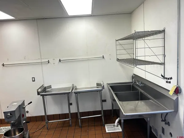a kitchen that has a sink and a stove in it