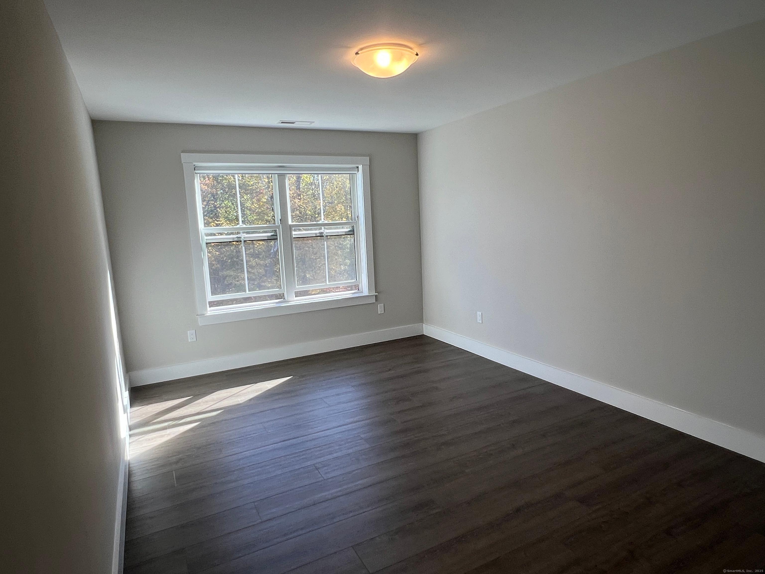 37 Old Rte 7, Unit 4 Brookfield, CT 06804 - Photo 17 of 22 an empty room with wooden floor and a window