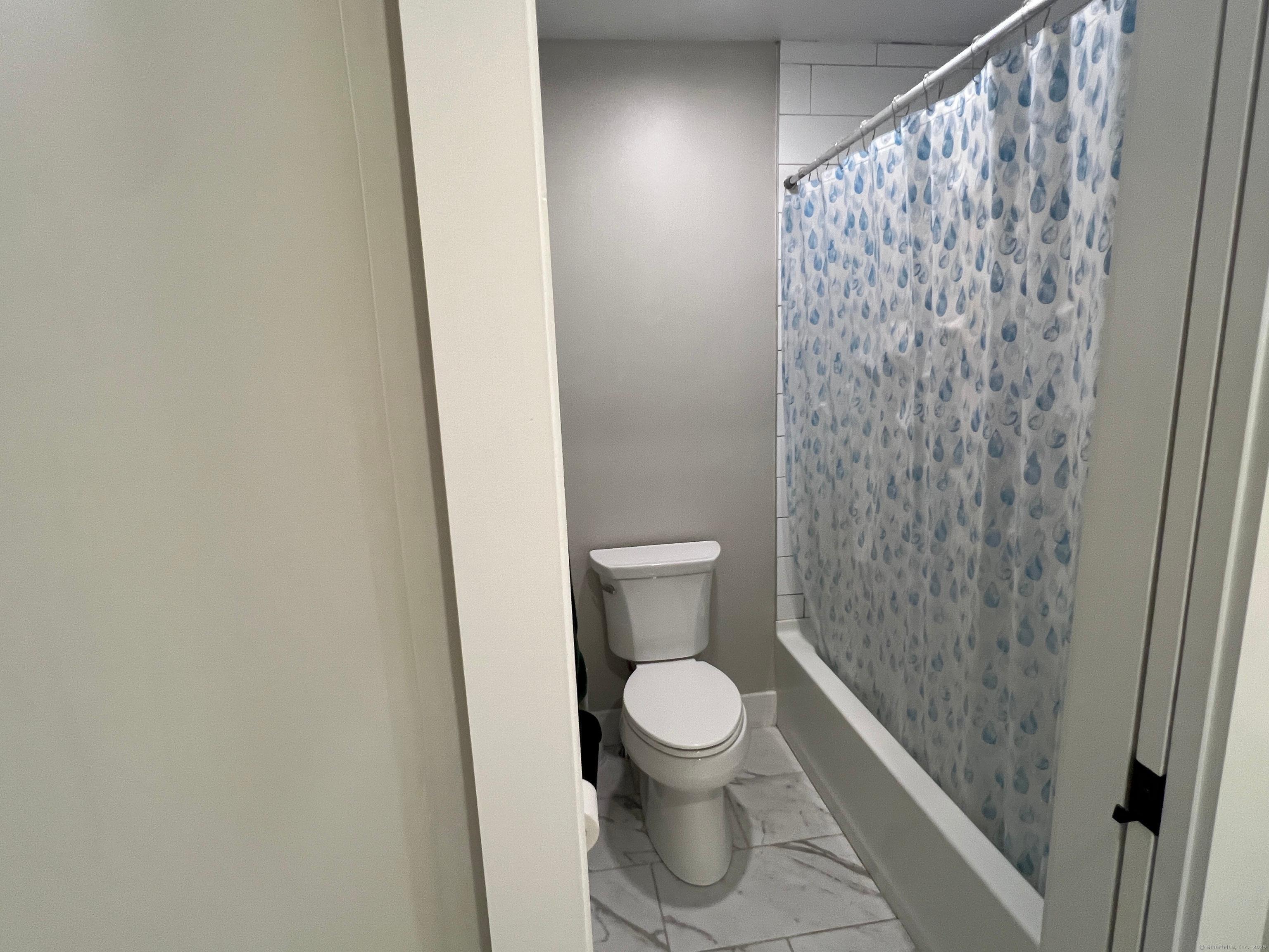 37 Old Rte 7, Unit 4 Brookfield, CT 06804 - Photo 21 of 22 a white toilet sitting next to a shower curtain