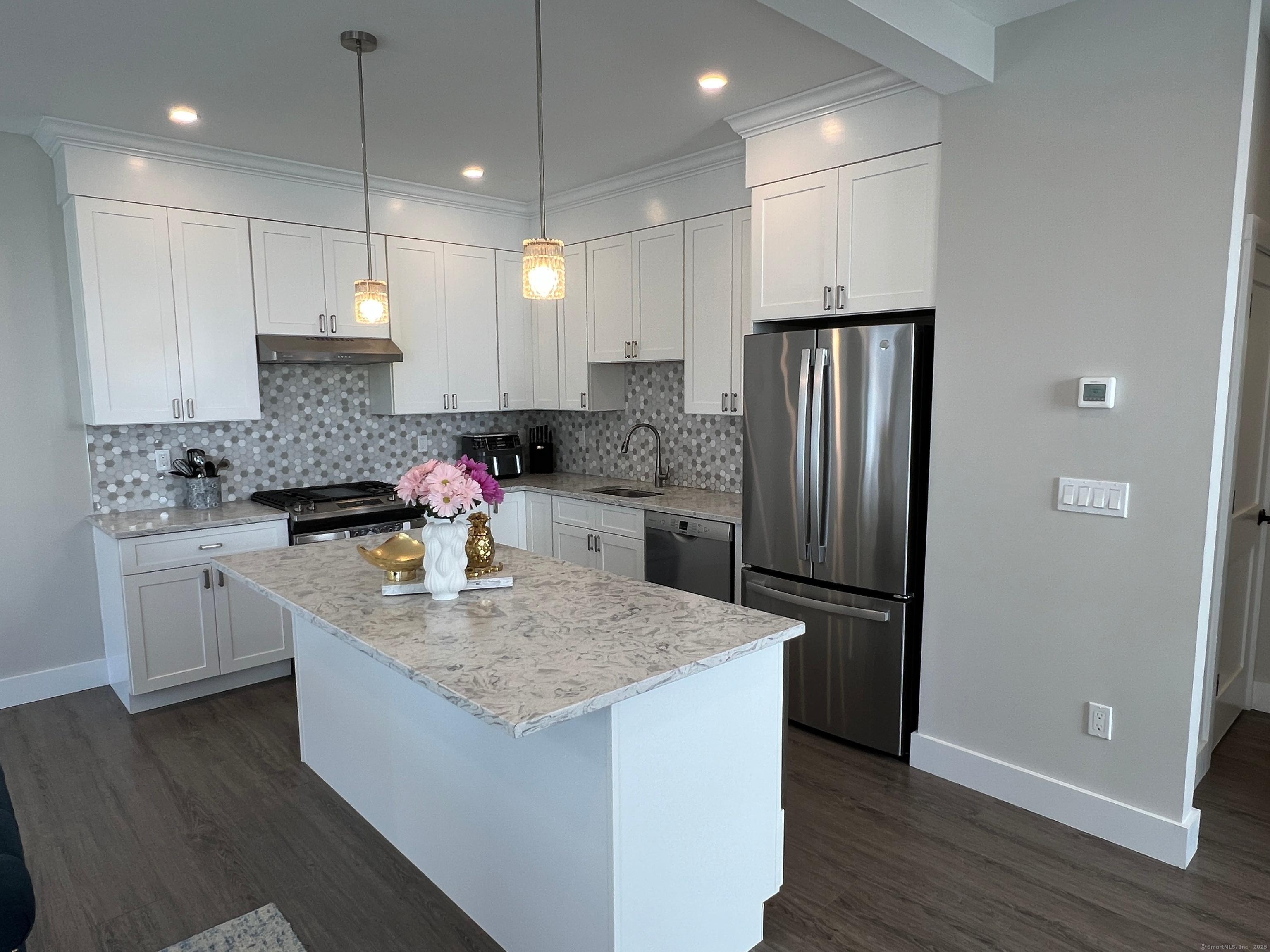 37 Old Rte 7, Unit 4 Brookfield, CT 06804 - Photo 3 of 22 a kitchen with stainless steel appliances granite countertop a sink refrigerator and cabinets