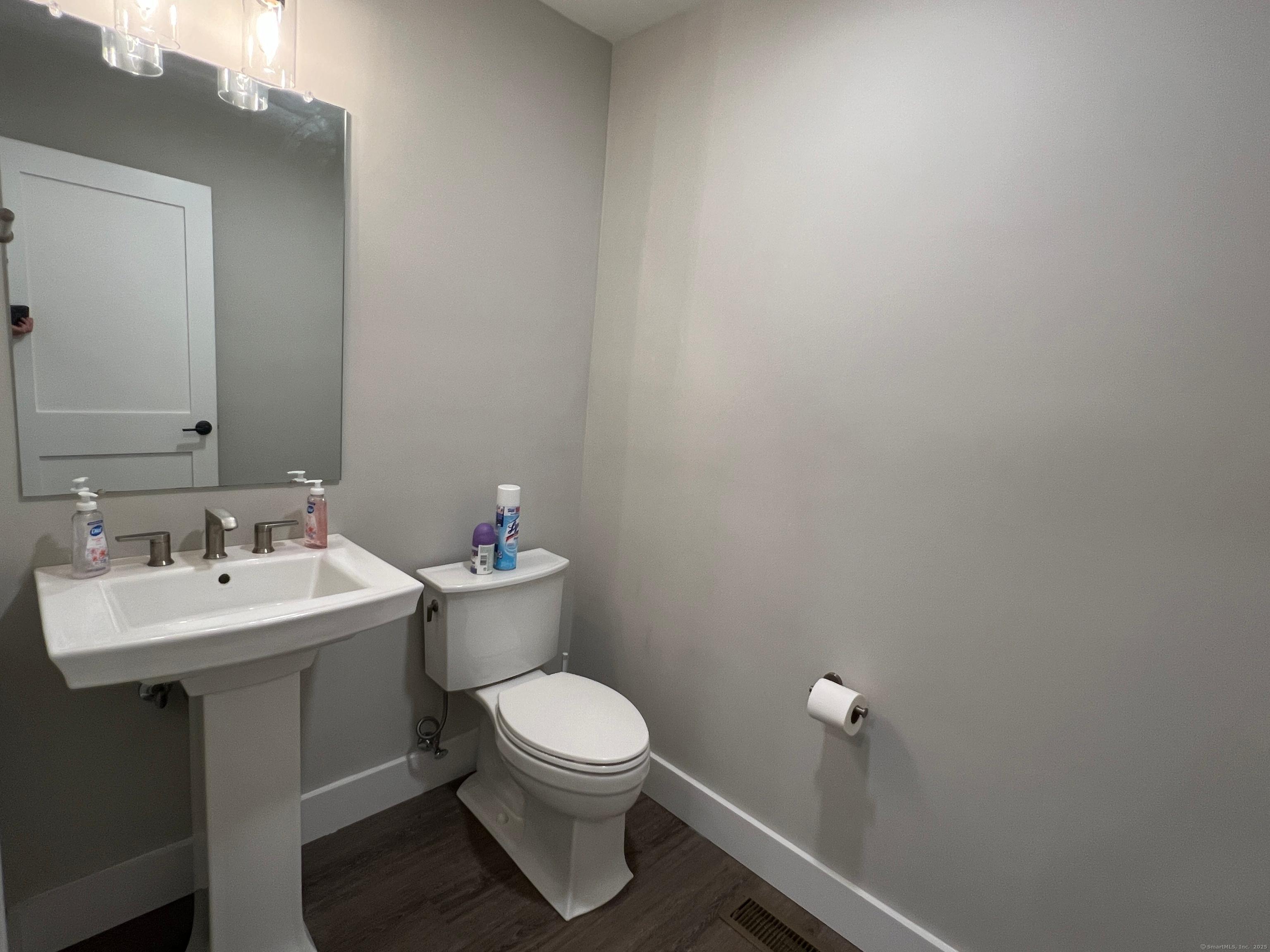 37 Old Rte 7, Unit 4 Brookfield, CT 06804 - Photo 8 of 22 a bathroom with a white toilet sink and mirror