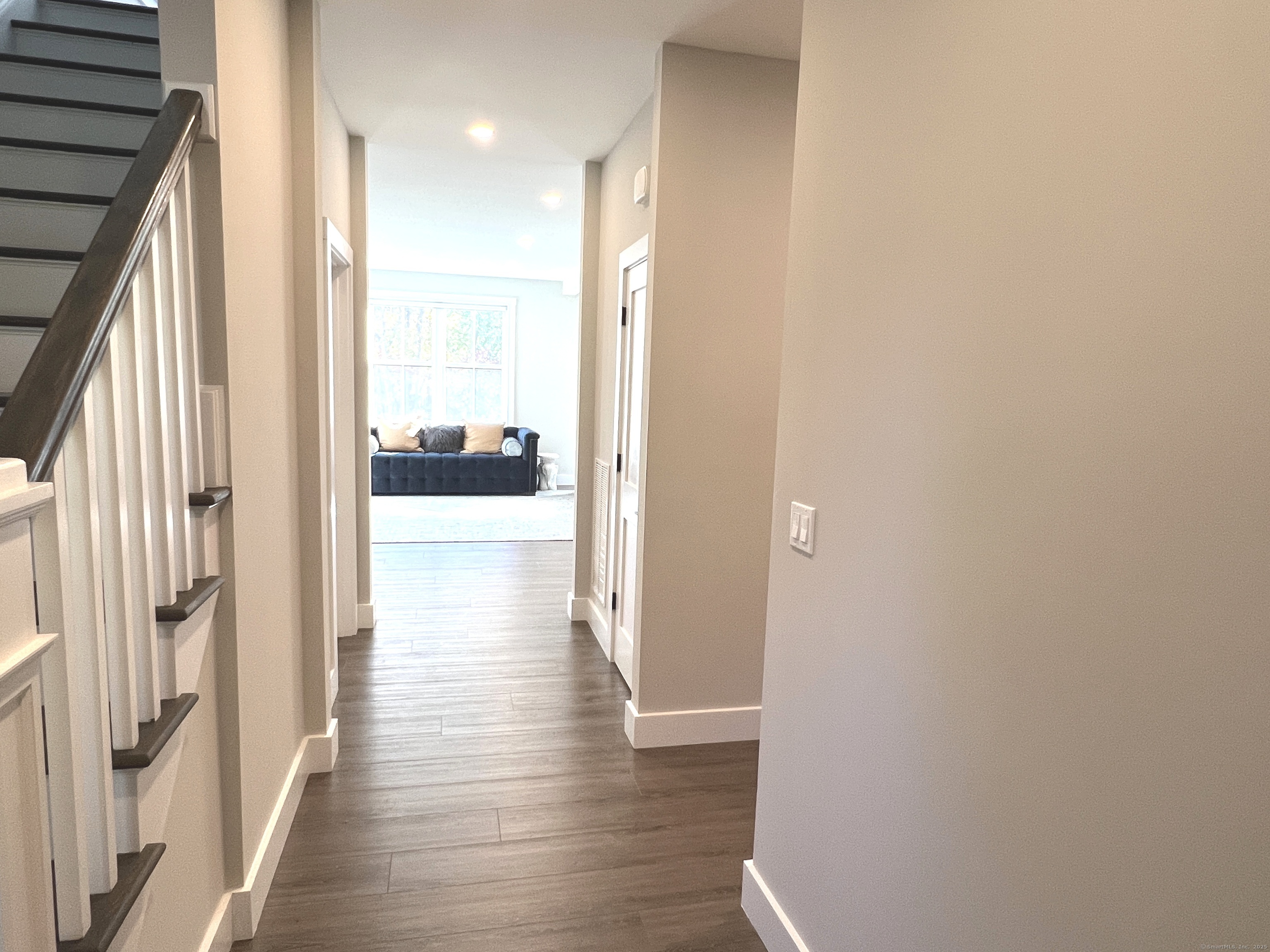 37 Old Rte 7, Unit 4 Brookfield, CT 06804 - Photo 9 of 22 a view of a hallway with wooden floor and a bathroom with a sink